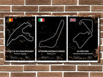 Three racing circuit posters on a brick wall