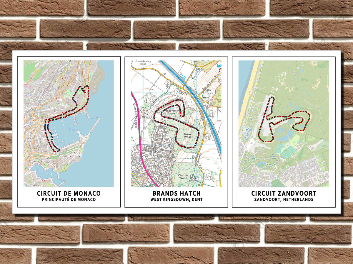 Three framed maps of different circuits on a brick wall.