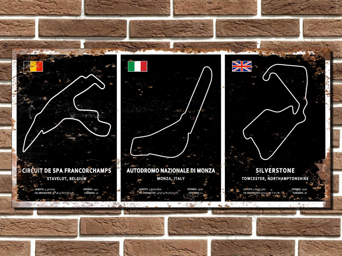 Three racing circuit posters on a brick wall