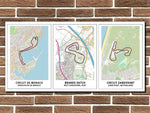 Three framed maps of different circuits on a brick wall.